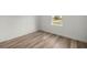 Bedroom with wood-look floors and a window at 75 Guava Ter, Ocklawaha, FL 32179