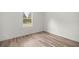 Bedroom with wood-look floors and a window at 75 Guava Ter, Ocklawaha, FL 32179