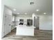 A bright kitchen with stainless steel appliances, an island with seating, and ample cabinet space at 75 Guava Ter, Ocklawaha, FL 32179