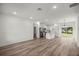 Open-concept living room and kitchen featuring stainless steel appliances and sliding glass doors to the outdoors at 75 Guava Ter, Ocklawaha, FL 32179