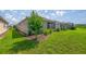 Scenic backyard with a vibrant lawn, a beautiful tree, and an enclosed lanai at 7881 Sw 89Th Cir, Ocala, FL 34481