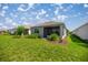 Well-maintained backyard with lush green lawn and screened-in lanai, perfect for outdoor living at 7881 Sw 89Th Cir, Ocala, FL 34481