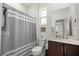 Bathroom with a shower, toilet, vanity, and natural light from a window at 7881 Sw 89Th Cir, Ocala, FL 34481