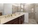 Bathroom showcasing double sinks, modern countertops, and a glass-enclosed tiled shower at 7881 Sw 89Th Cir, Ocala, FL 34481