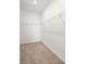Walk-in closet provides ample storage with white wire shelving and neutral carpeting at 7881 Sw 89Th Cir, Ocala, FL 34481