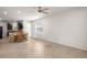 Well-lit dining area showcasing tile flooring, a ceiling fan, and an open layout connecting to the kitchen at 7881 Sw 89Th Cir, Ocala, FL 34481