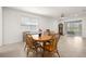 Spacious dining area featuring tile floors, ceiling fan, bright natural light, and a wooden dining table at 7881 Sw 89Th Cir, Ocala, FL 34481