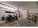 Spacious garage featuring a golf cart, concrete flooring, and ample storage space at 7881 Sw 89Th Cir, Ocala, FL 34481
