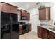 The kitchen features granite countertops, dark wood cabinets, and stainless steel appliances at 7881 Sw 89Th Cir, Ocala, FL 34481