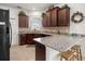 The kitchen showcases granite countertops, dark wood cabinets, a breakfast bar, and updated appliances at 7881 Sw 89Th Cir, Ocala, FL 34481