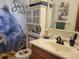 Bathroom featuring decorative wallpaper, vanity, and framed mirror at 8343 Sw 105Th Pl, Ocala, FL 34481