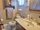 Bathroom featuring a vanity, toilet, and storage shelves at 8343 Sw 105Th Pl, Ocala, FL 34481