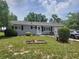 Charming single-story home featuring a well-manicured lawn and inviting front porch at 8343 Sw 105Th Pl, Ocala, FL 34481