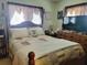 Well-lit bedroom with a queen-size bed, dresser, and two windows at 8343 Sw 105Th Pl, Ocala, FL 34481