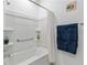 Simple tub/shower bathroom with nice shelving and a towel rack at 8802 Sw 79Th Loop, Ocala, FL 34481