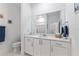Bright bathroom with modern vanity, decorative towels, and a toilet; features a large mirror at 8802 Sw 79Th Loop, Ocala, FL 34481
