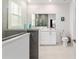 Modern bathroom with glass-enclosed shower, gray accent wall, and spacious vanity at 8802 Sw 79Th Loop, Ocala, FL 34481