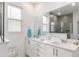Bright bathroom featuring double sinks, modern fixtures, and an open shower at 8802 Sw 79Th Loop, Ocala, FL 34481