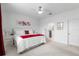 Bright bedroom featuring a cozy bed, white furnishings, and a glimpse of the ensuite bathroom at 8802 Sw 79Th Loop, Ocala, FL 34481