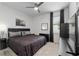 Bedroom with carpet floors, a ceiling fan, and a queen bed with dark bedding at 8802 Sw 79Th Loop, Ocala, FL 34481