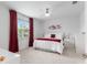 Well-lit bedroom with a comfortable queen-size bed, a ceiling fan, and a view from the window at 8802 Sw 79Th Loop, Ocala, FL 34481