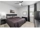 Bedroom with carpet floors, a ceiling fan, and a queen bed with dark bedding and a nightstand at 8802 Sw 79Th Loop, Ocala, FL 34481