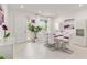 Bright dining room features a modern table set for six, complemented by stylish decor and ample lighting at 8802 Sw 79Th Loop, Ocala, FL 34481