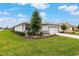 Attractive single-story home showcasing lush landscaping, a two-car garage, and a well-kept lawn at 8802 Sw 79Th Loop, Ocala, FL 34481