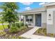 Inviting front porch with a classic blue door, enhanced by tasteful landscaping and exterior lighting at 8802 Sw 79Th Loop, Ocala, FL 34481