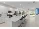 Bright, open kitchen features stainless steel appliances, white cabinets, and a large center island with bar seating at 8802 Sw 79Th Loop, Ocala, FL 34481