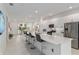The modern kitchen offers sleek white cabinets, stainless steel appliances, and a spacious island with seating at 8802 Sw 79Th Loop, Ocala, FL 34481