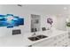 Bright kitchen shows stainless steel sink and fixtures, and ample counter space and storage at 8802 Sw 79Th Loop, Ocala, FL 34481
