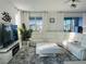 Cozy living room with white leather furniture, a large TV, and neutral grey rug at 8802 Sw 79Th Loop, Ocala, FL 34481