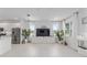 Modern living room with tile flooring, large windows, and a media center at 8802 Sw 79Th Loop, Ocala, FL 34481