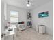 Bright home office space featuring a ceiling fan, desk, and storage units with carpet flooring at 8802 Sw 79Th Loop, Ocala, FL 34481