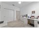 Bright home office space with neutral carpet, a closet, and a white desk area at 8802 Sw 79Th Loop, Ocala, FL 34481