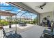 This screened-in lanai features lots of seating, great sun protection, and backyard views at 8802 Sw 79Th Loop, Ocala, FL 34481