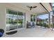 This covered patio has a ceiling fan, comfortable seating, and a view of the neighborhood at 8802 Sw 79Th Loop, Ocala, FL 34481