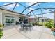 Spacious screened-in patio with modern outdoor furniture and lush landscaping at 8802 Sw 79Th Loop, Ocala, FL 34481