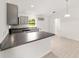 Bright kitchen features modern appliances, countertops, gray cabinets, and a breakfast bar at 9 Redwood Run Trce, Ocala, FL 34481