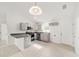 Well-lit kitchen features gray cabinets, a breakfast bar, modern appliances, and ample counter space at 9 Redwood Run Trce, Ocala, FL 34481