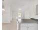 Kitchen featuring a breakfast bar, abundant natural light, and gray cabinets at 9 Redwood Run Trce, Ocala, FL 34481