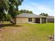 Back exterior view of the home featuring a screened patio and spacious backyard at 9432 Se 159Th Ln, Summerfield, FL 34491