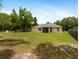 Back exterior view of the home featuring a screened patio and spacious backyard at 9432 Se 159Th Ln, Summerfield, FL 34491