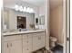 Well-lit bathroom featuring dual sinks, ample counter space, and modern fixtures at 9432 Se 159Th Ln, Summerfield, FL 34491