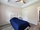 Charming bedroom with wood-look floors, closet, and bright window for a warm and inviting ambiance at 9432 Se 159Th Ln, Summerfield, FL 34491