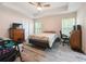 Comfortable bedroom with tray ceilings, natural light, and stylish furnishings at 9432 Se 159Th Ln, Summerfield, FL 34491