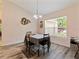 Cozy dining area with a charming window, pendant lighting, and unique wall decor at 9432 Se 159Th Ln, Summerfield, FL 34491