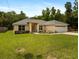 Charming single-story home with a well-manicured lawn, a two car garage and mature landscaping at 9432 Se 159Th Ln, Summerfield, FL 34491