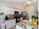 Functional kitchen with ample counter space, white cabinets, and stainless steel appliances at 9432 Se 159Th Ln, Summerfield, FL 34491
